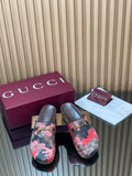 Gucci slide sandals with pink and black patterned canvas and gold-tone logo buckle