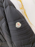 Moncler long puffer jacket sleeve with logo patch on dark quilted shoulder