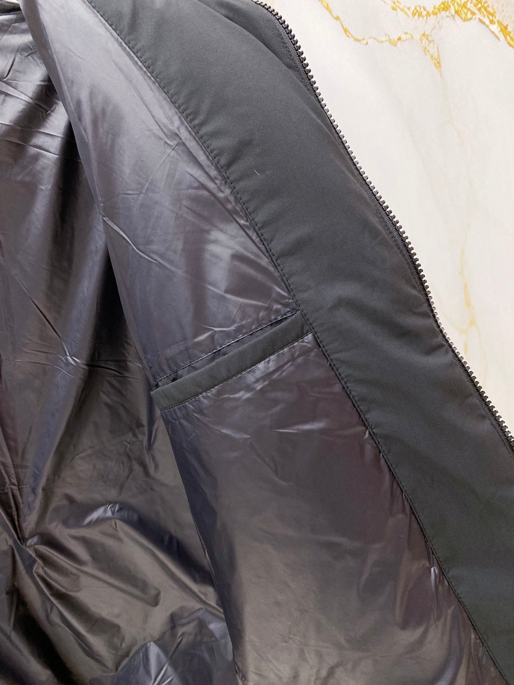 Moncler long puffer jacket interior panel with zip and stitched pocket lining