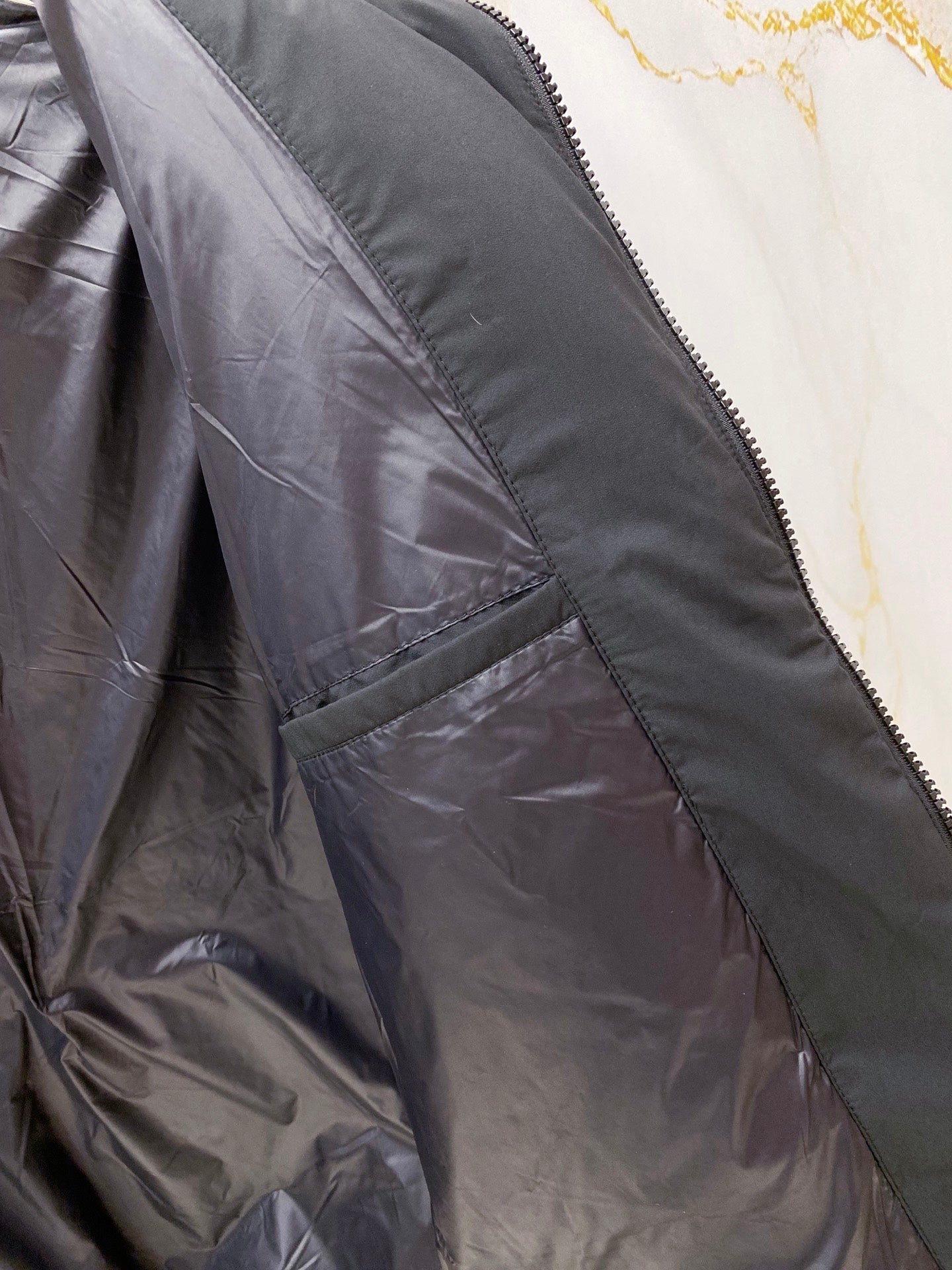Moncler long puffer jacket interior panel with zip and stitched pocket lining