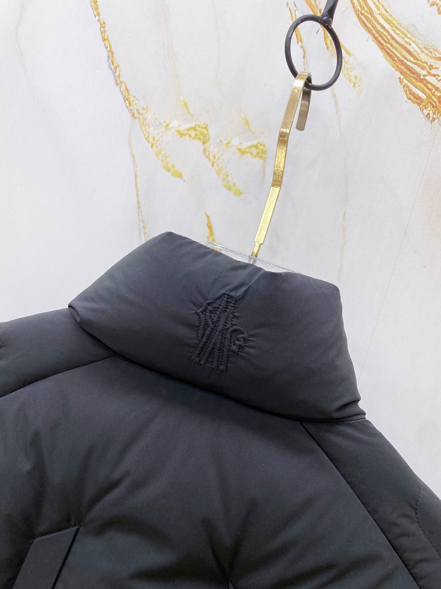 Moncler long puffer jacket hood and collar with dark padded quilting