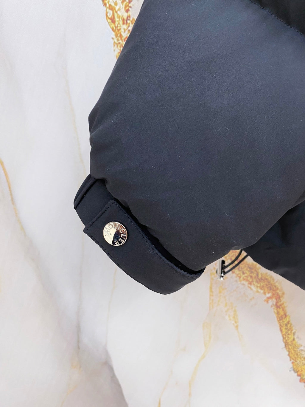 Moncler long puffer jacket cuff and sleeve with small logo patch