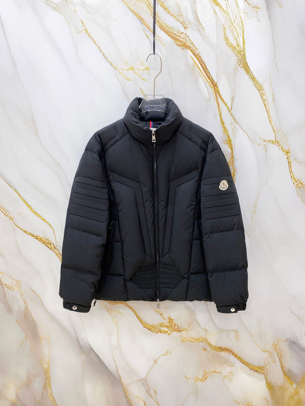Moncler long puffer jacket with hood, full zip, and dark quilted panels