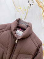 Moncler puffer jacket front, dark brown with zipper and inner logo label.