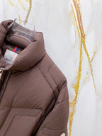 Moncler puffer jacket side panel and pocket, dark brown quilted padding.