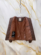 Moncler puffer jacket front view, dark brown quilted panels with inner tag.