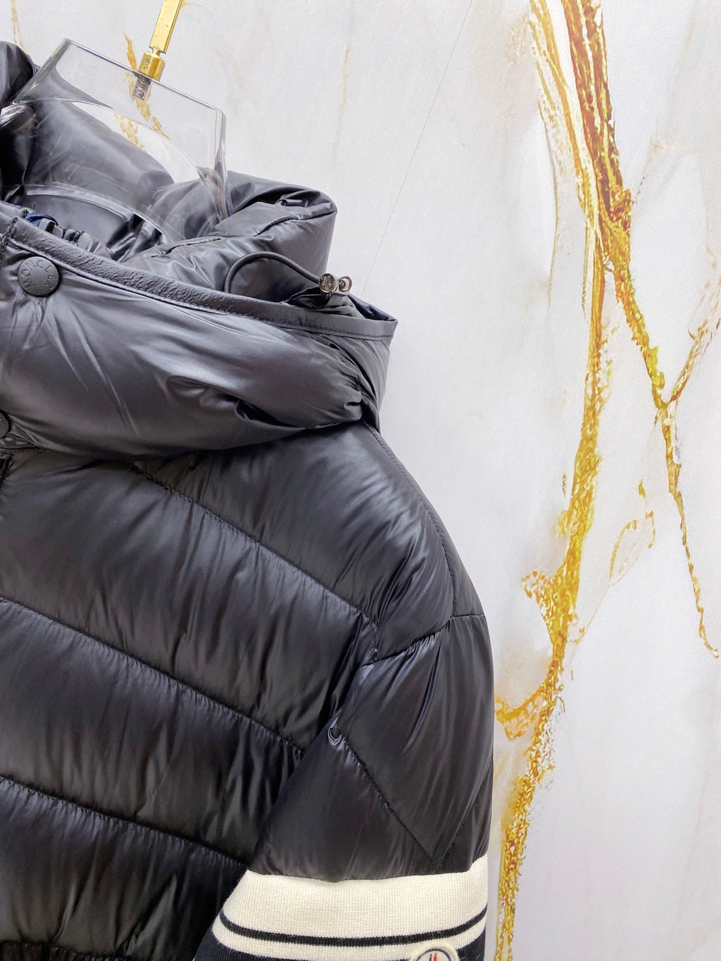 Long puffer jacket with striped knit cuff trim at the wrist
