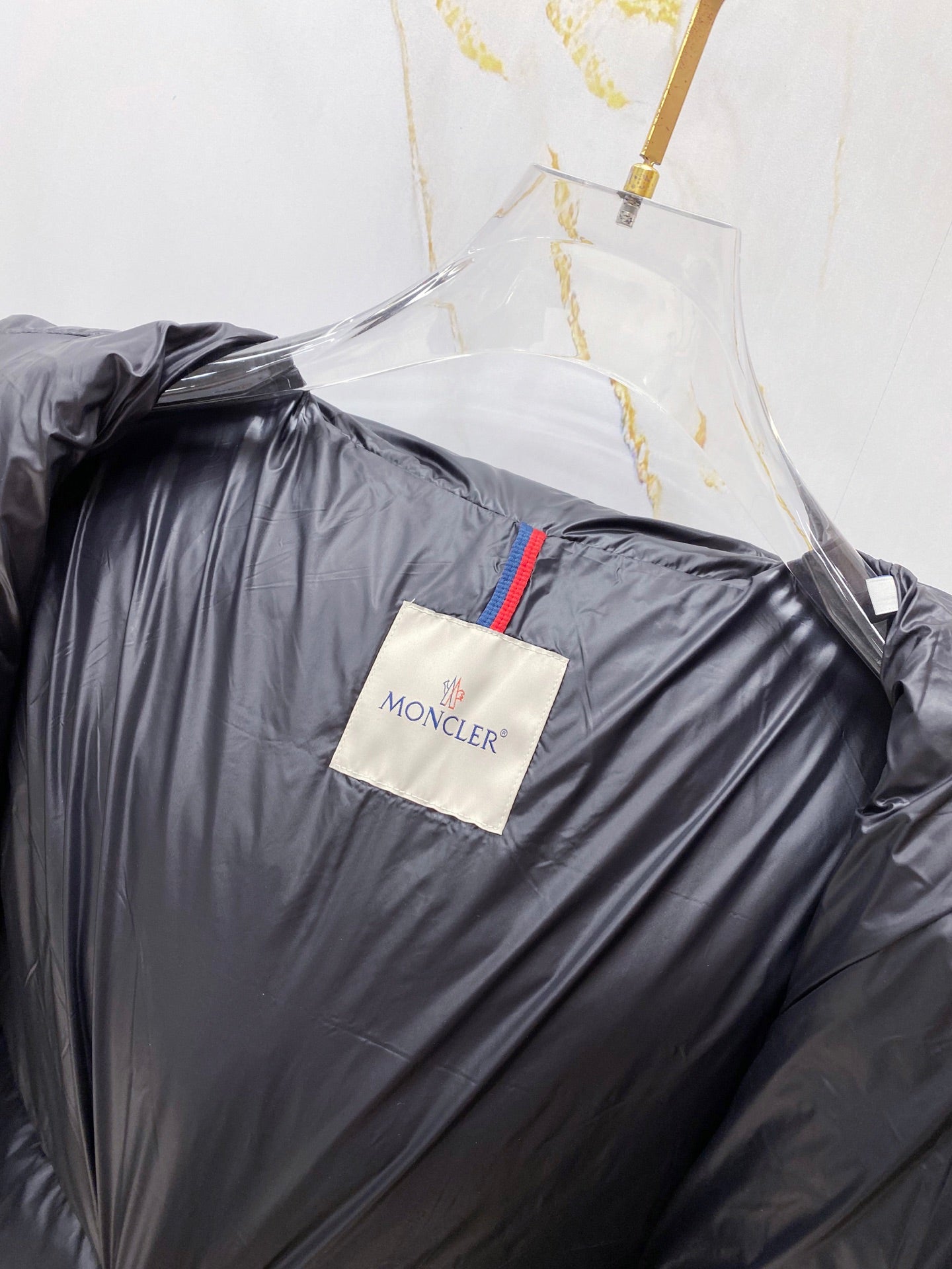 Puffer jacket front panel with chest logo tag and side press-stud