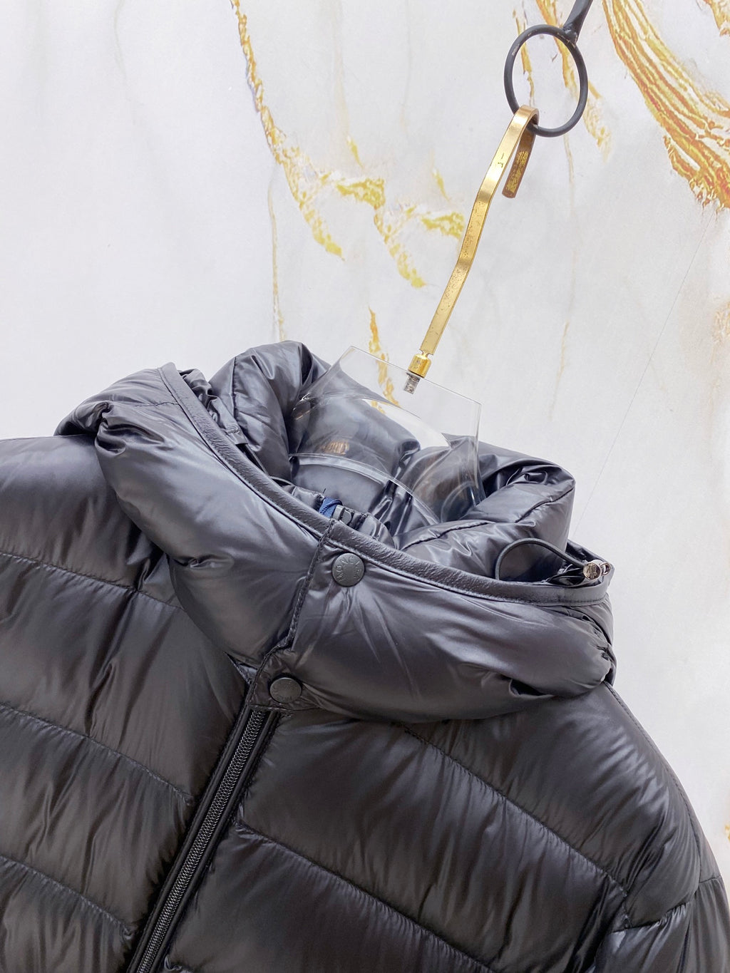 Long puffer jacket sleeve and shoulder with dark side zipper and button detail