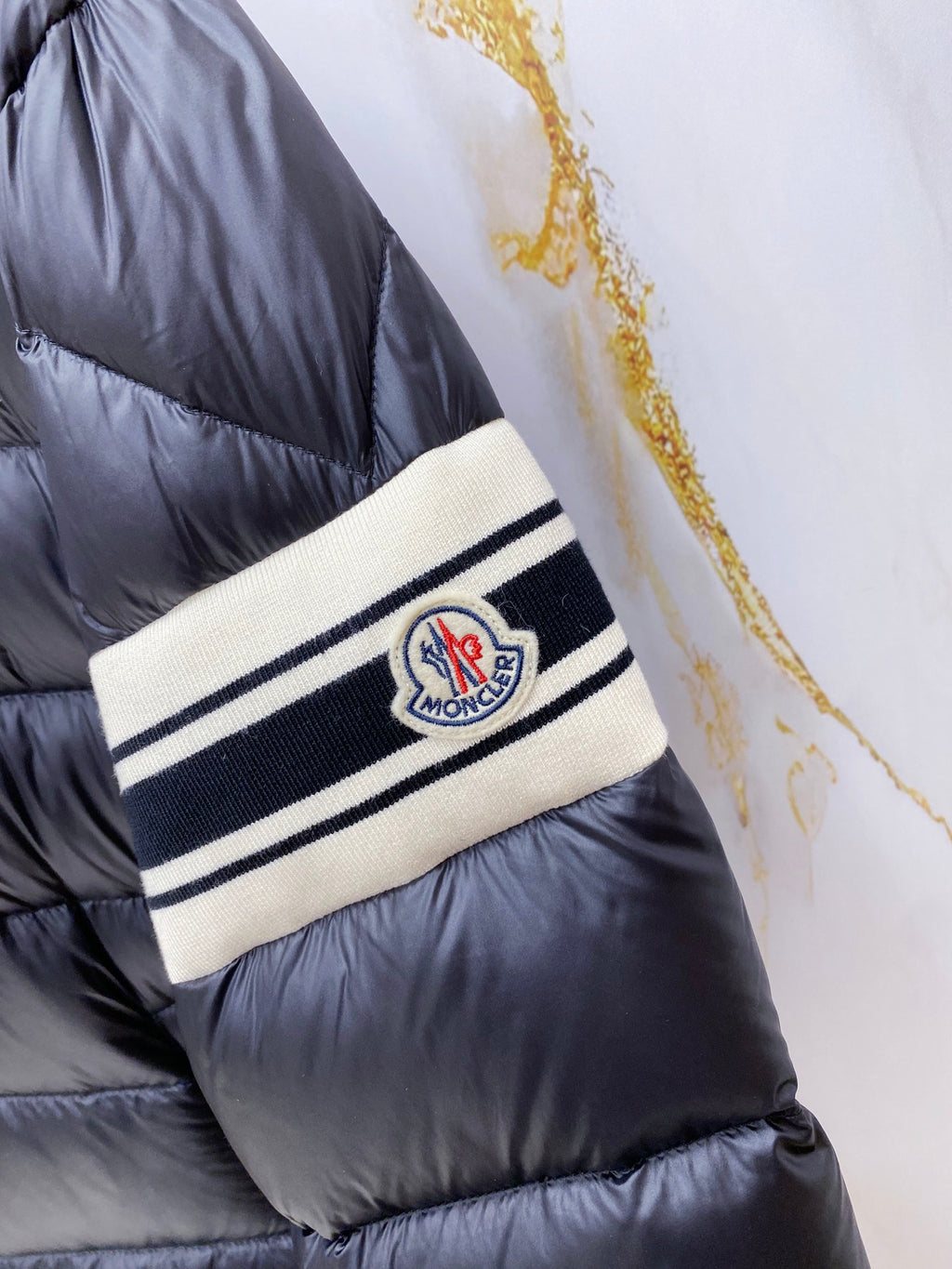 Long puffer jacket wrist band with Moncler logo patch and striped trim