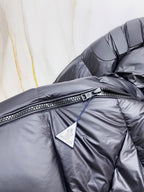 Moncler long puffer jacket chest close-up, dark navy with zip and logo patch