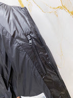 Moncler long puffer jacket front close-up, dark navy with full-length zipper