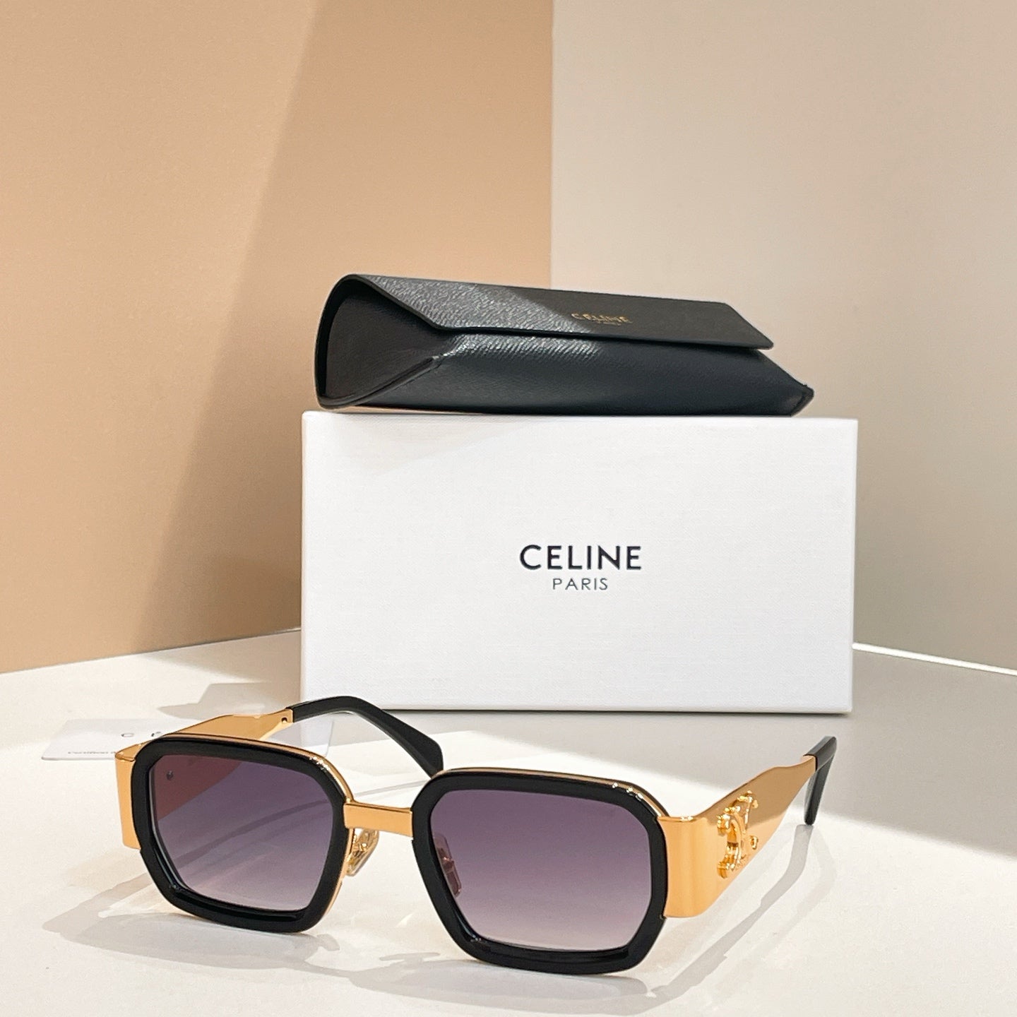 Celine square sunglasses with black frames, gold accents, and tinted lenses.