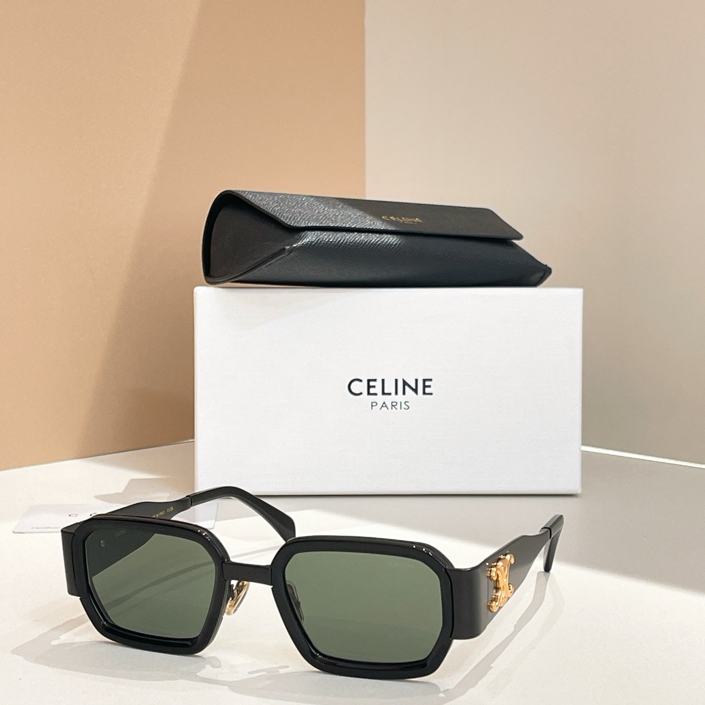 Celine square sunglasses with dark frames and green tinted lenses.