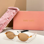 Round sunglasses with amber-brown lenses and gold-tone frames, curved temples