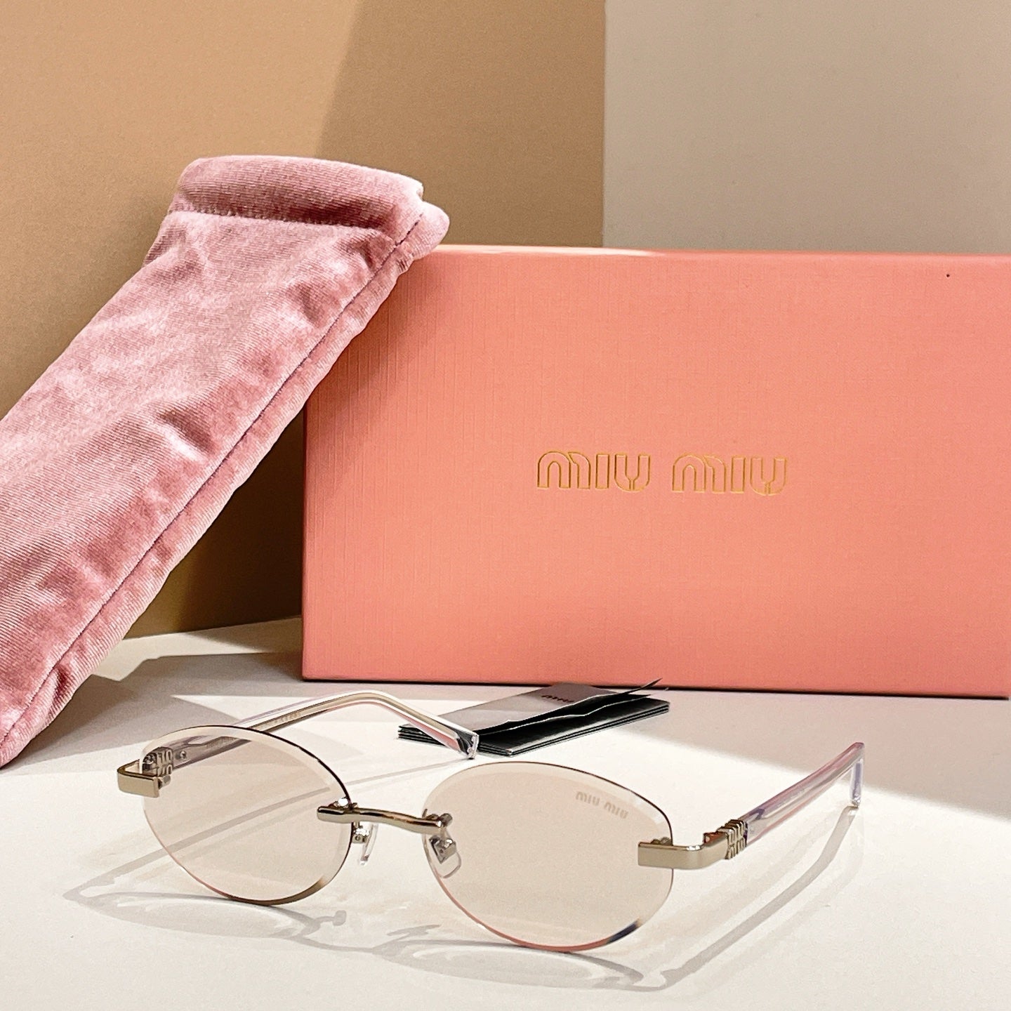 Round sunglasses with clear lenses and gold-tone frames, slim arms