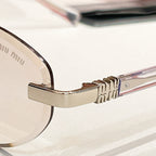 Round sunglasses close-up: gold-tone hinge and curved temple arm