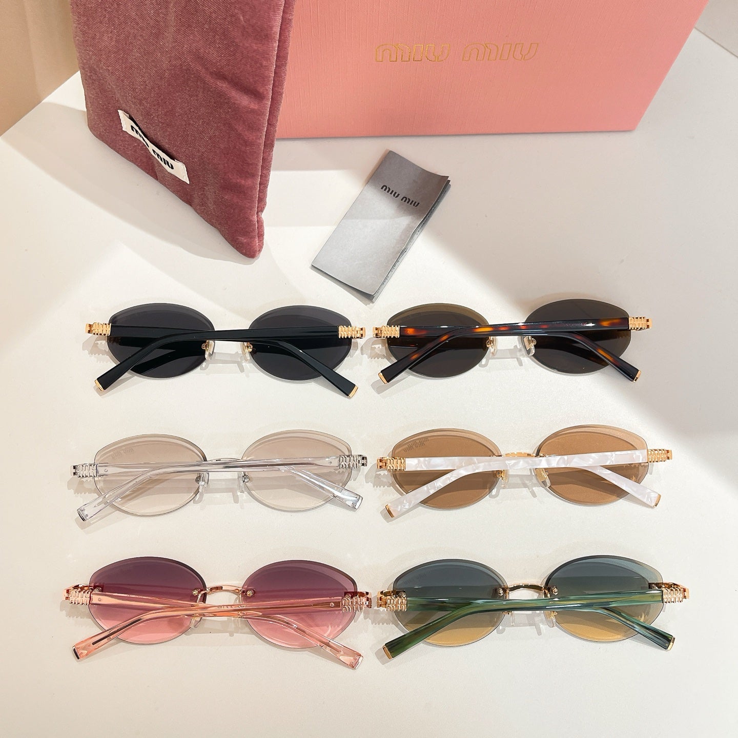 Assorted round sunglasses set with clear, brown, pink, and green lenses, gold-tone frames