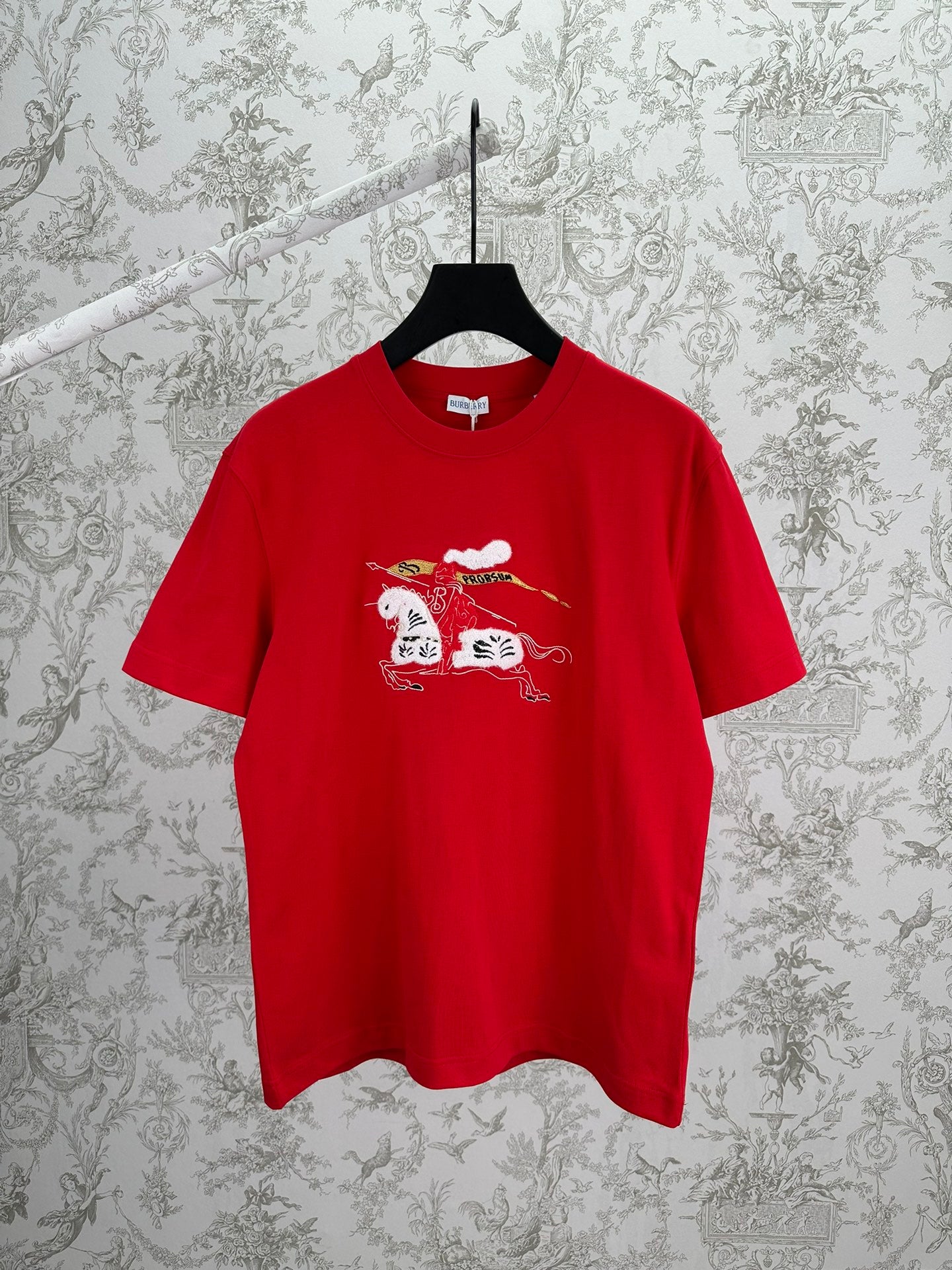 Red graphic T-shirt with crew neck and short sleeves, front print of cat and cloud