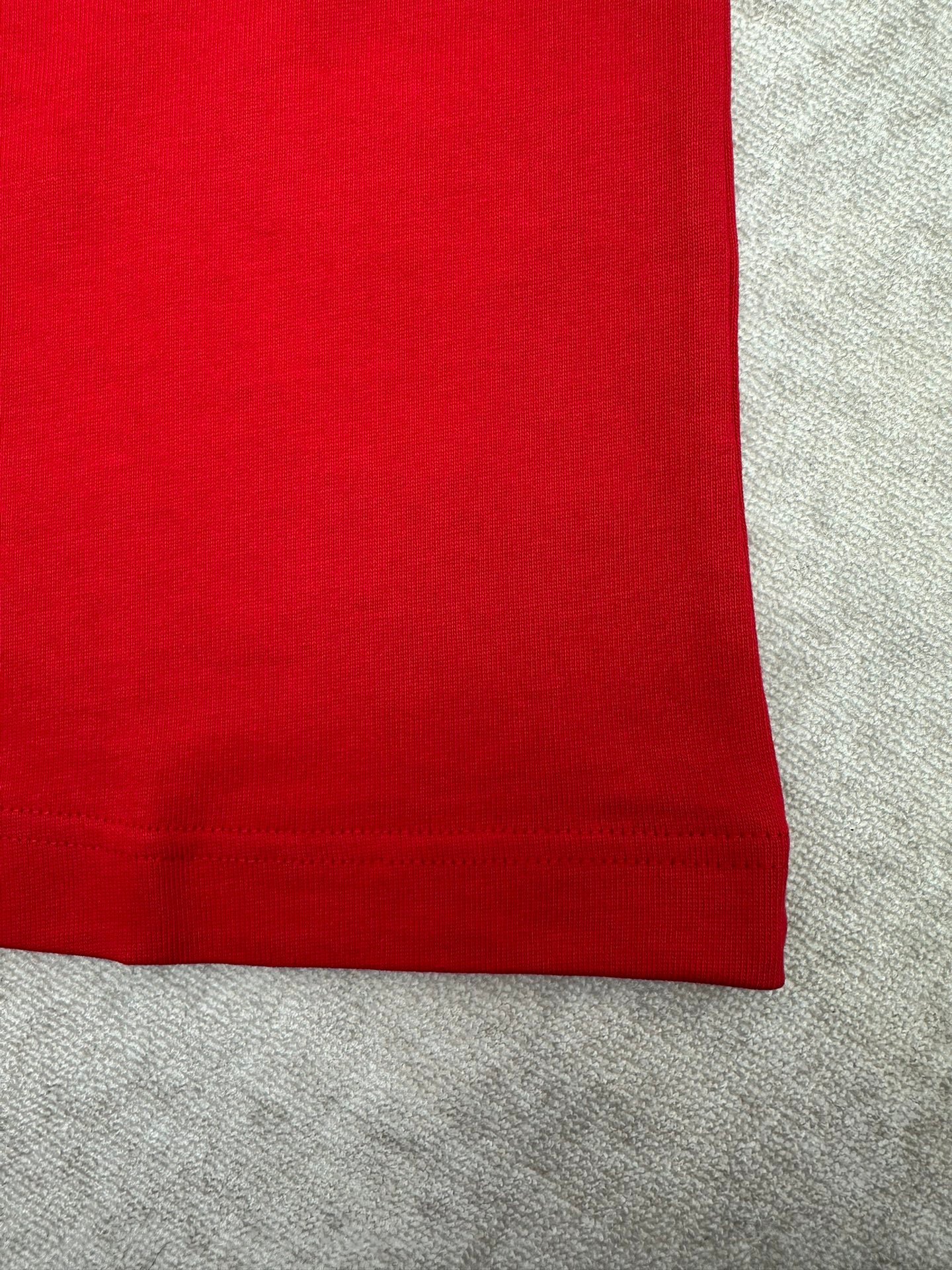 Red T-shirt hem with ribbed cuff trim on short sleeve