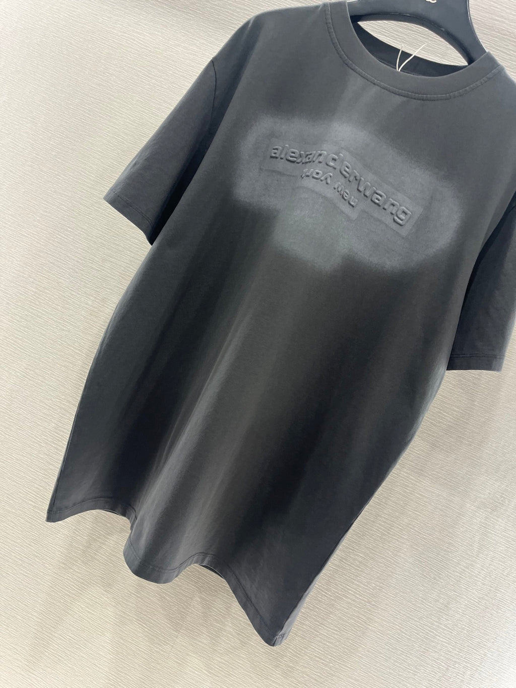 Dark gray crew-neck short-sleeve T-shirt with centered chest logo print