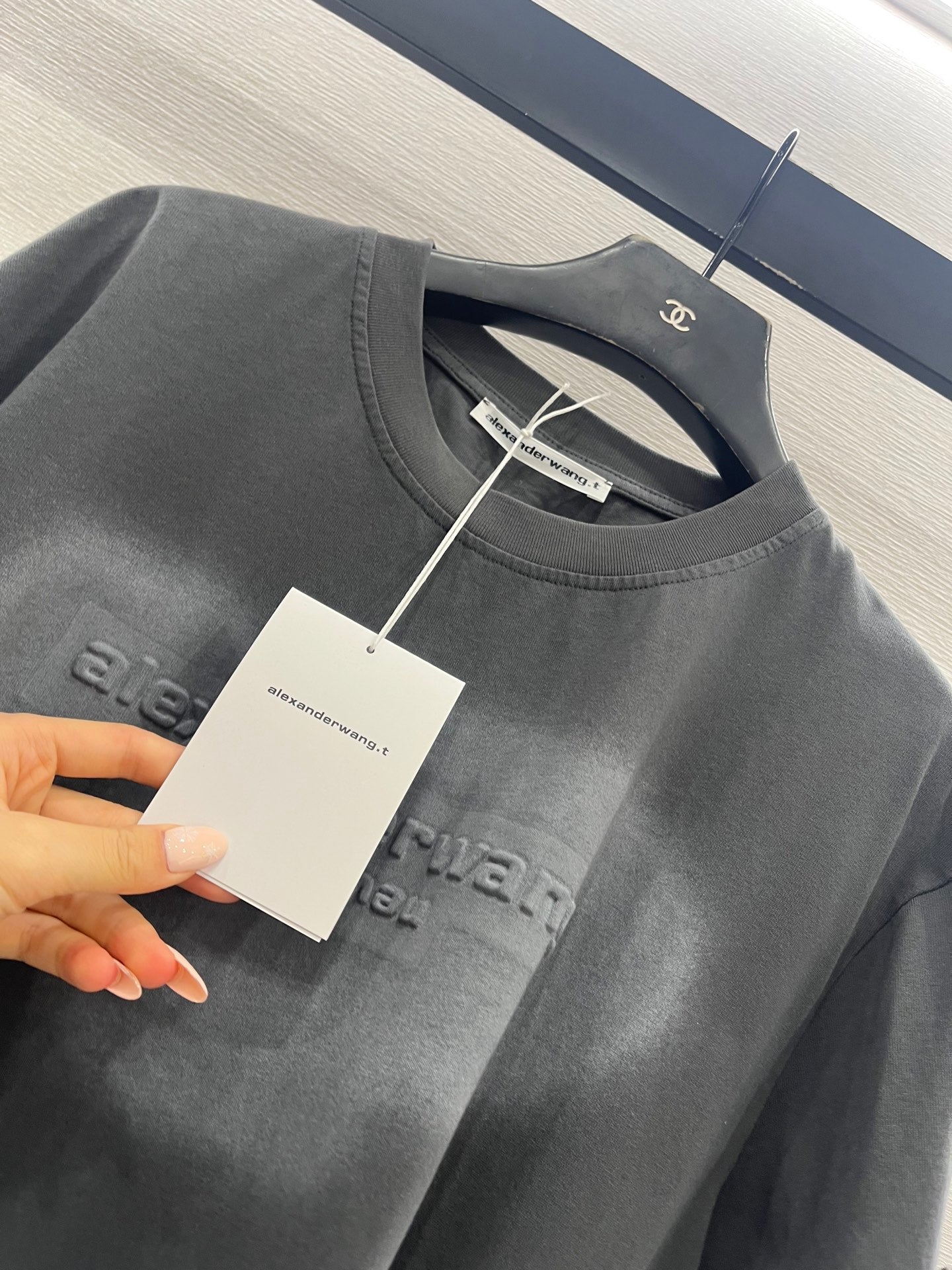 Dark gray crew-neck T-shirt neckline with inner label and partial chest print