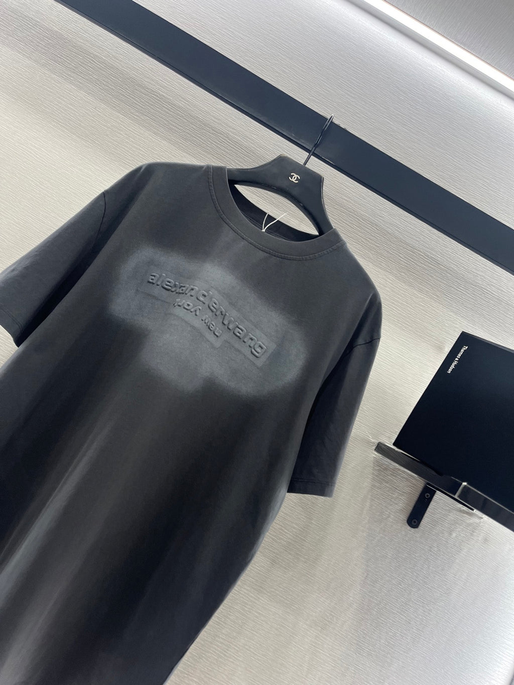 Dark gray crew-neck short-sleeve T-shirt with embossed-style chest logo print