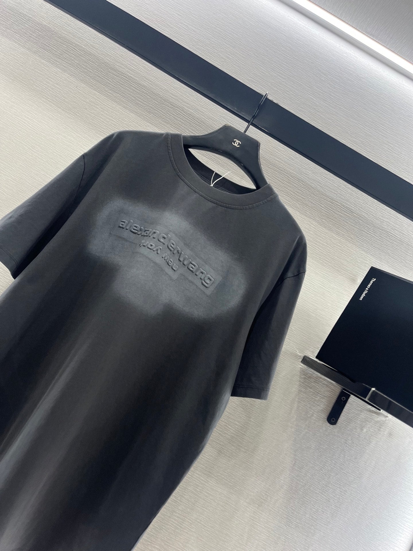 Dark gray crew-neck short-sleeve T-shirt with embossed-style chest logo print