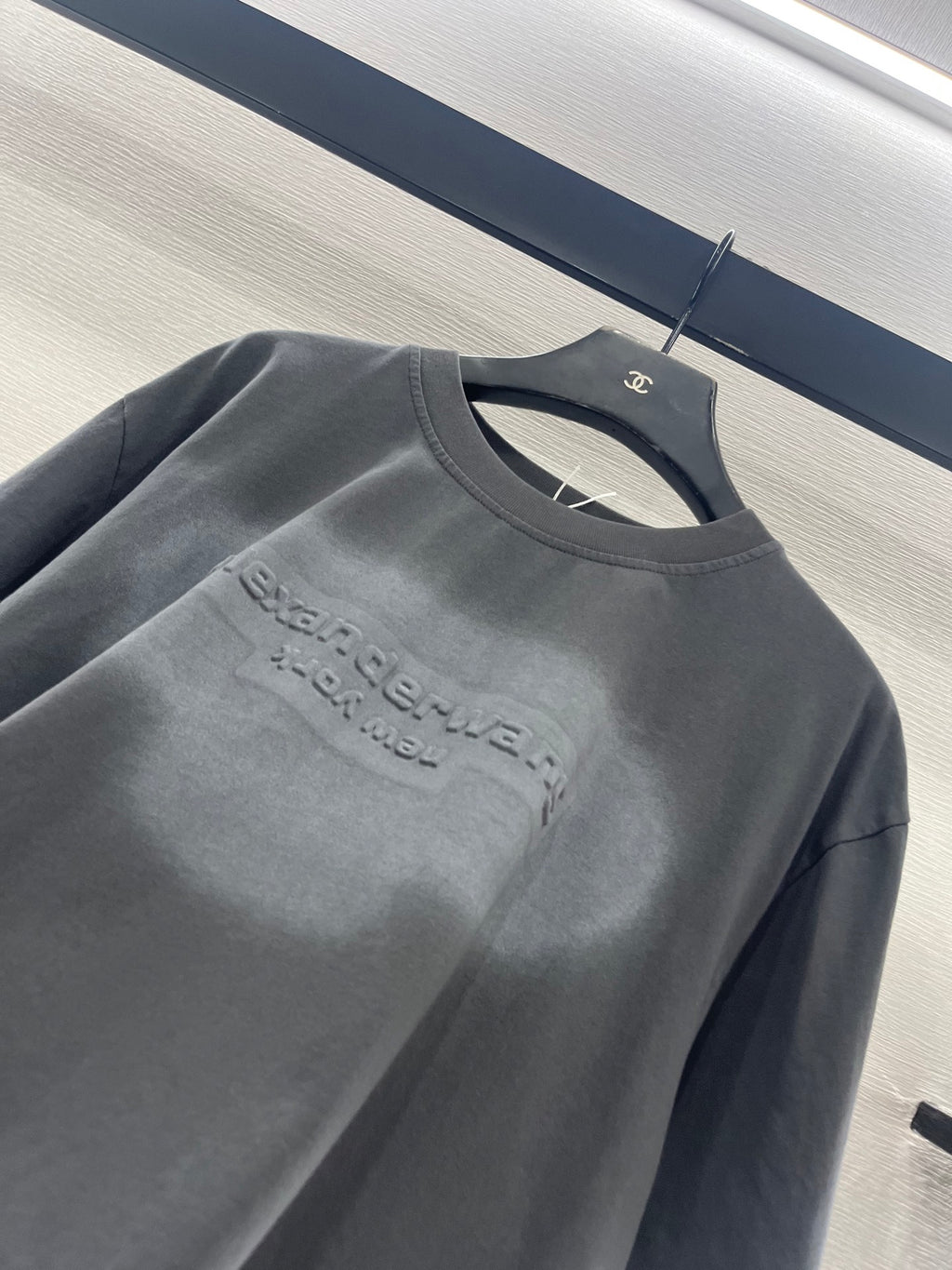 Dark gray short-sleeve crew-neck T-shirt with chest logo graphic detail