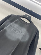 Dark gray short-sleeve crew-neck T-shirt with chest logo graphic detail