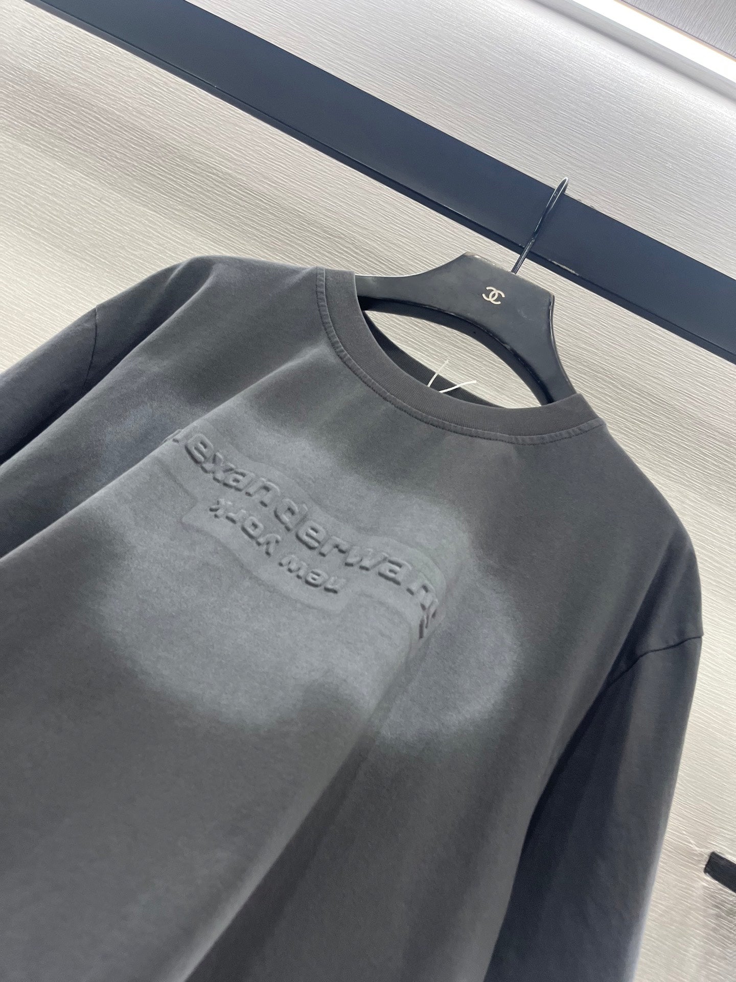 Dark gray short-sleeve crew-neck T-shirt with chest logo graphic detail