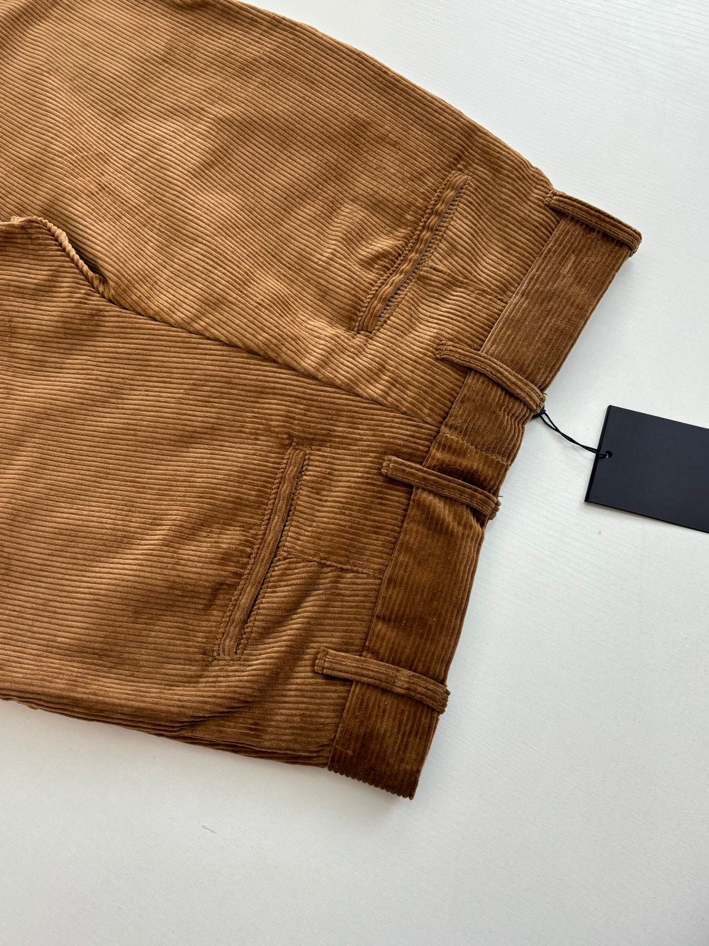Tan corduroy pants with belt loops and front button