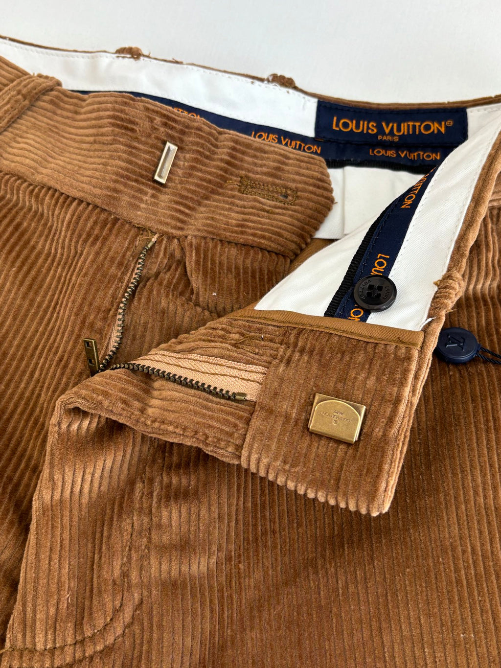 Louis Vuitton brown corduroy pants waistband and front details, including label tags