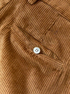 Corduroy pants detail: round button and welt pocket