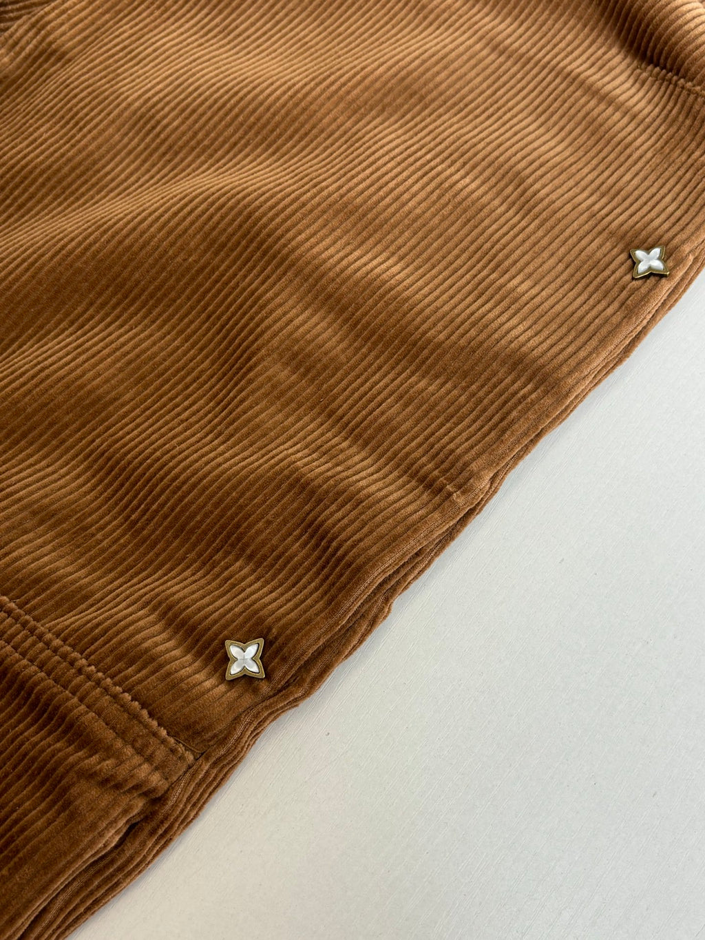 Louis Vuitton brown corduroy pant cuff with small star-shaped embellishments