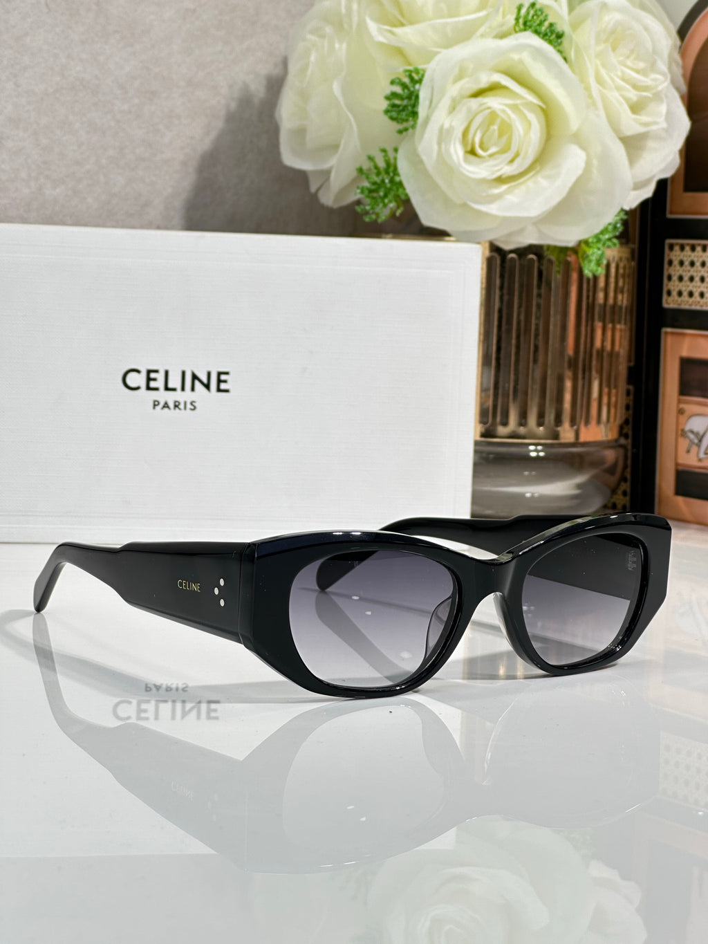 Celine sunglasses with black frames and dark lenses, angled side view