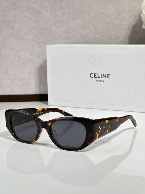 Celine sunglasses with black frames, tortoise temples, and dark round lenses