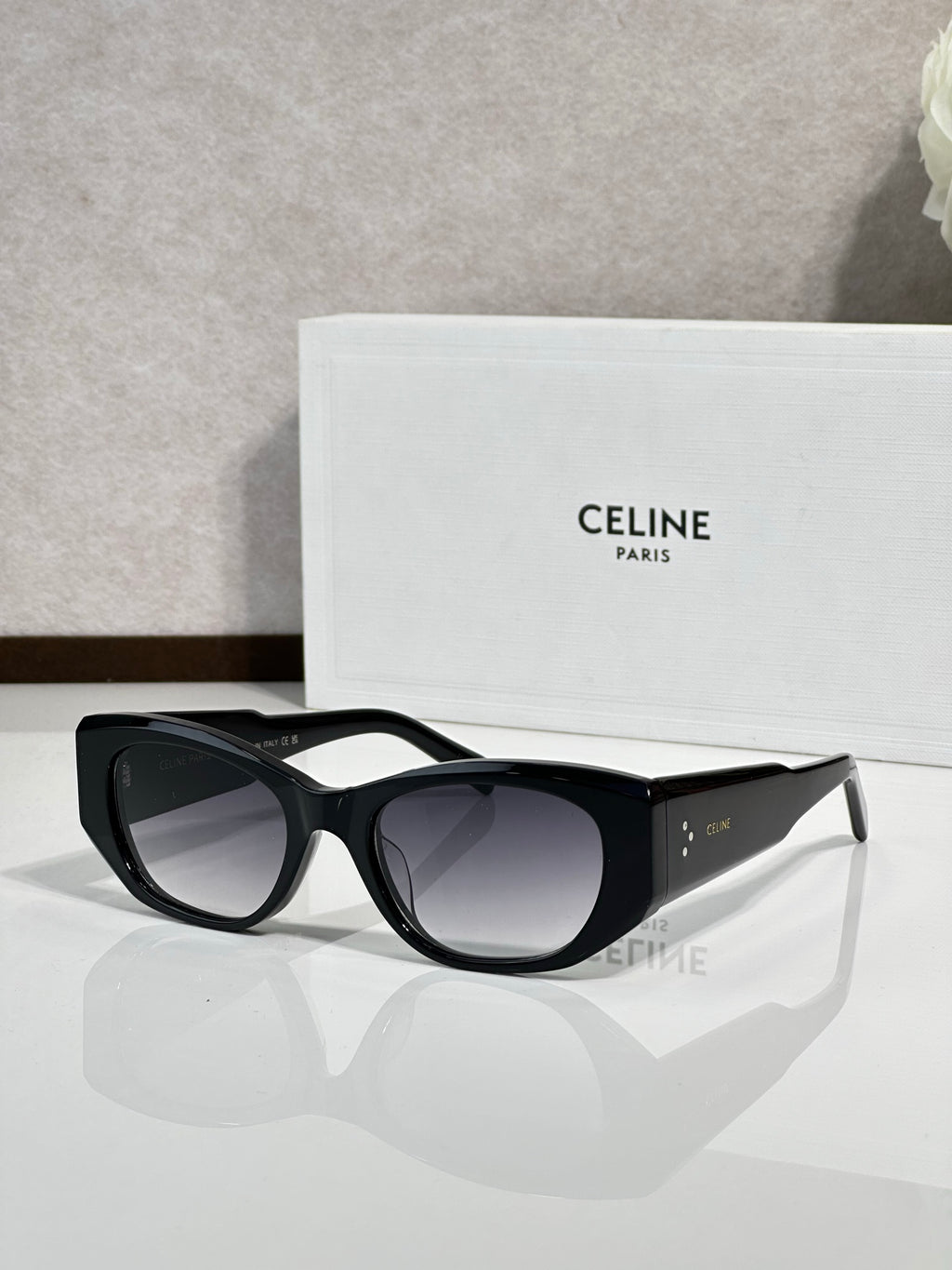 Celine sunglasses with black frames and dark gray tinted lenses