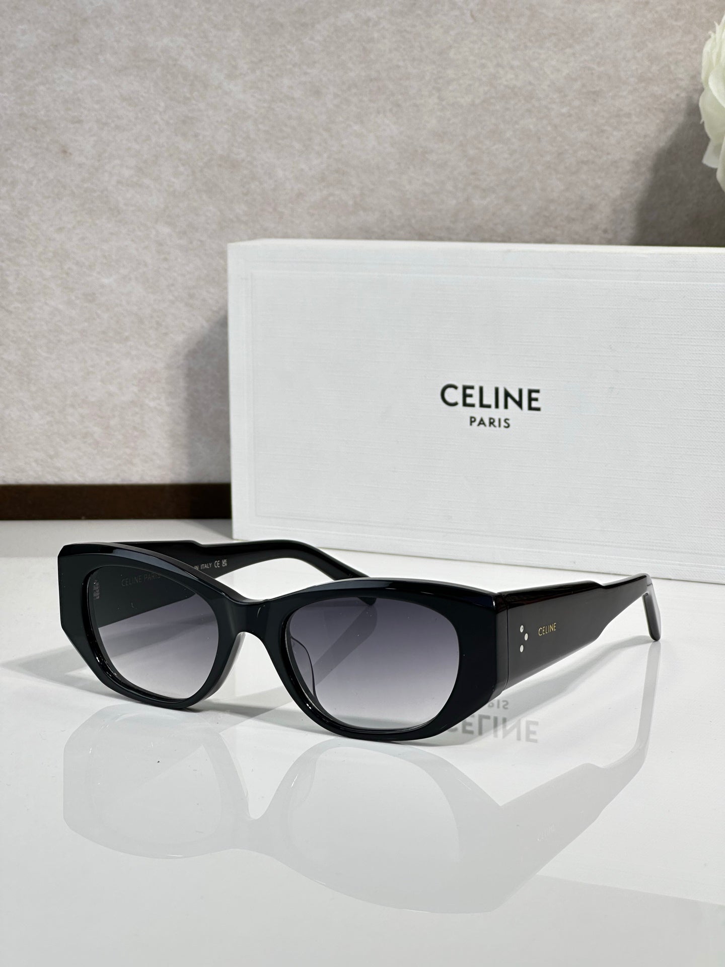Celine sunglasses with black frames and dark gray tinted lenses