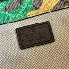 Gucci-stamped leather brand patch inside camo backpack