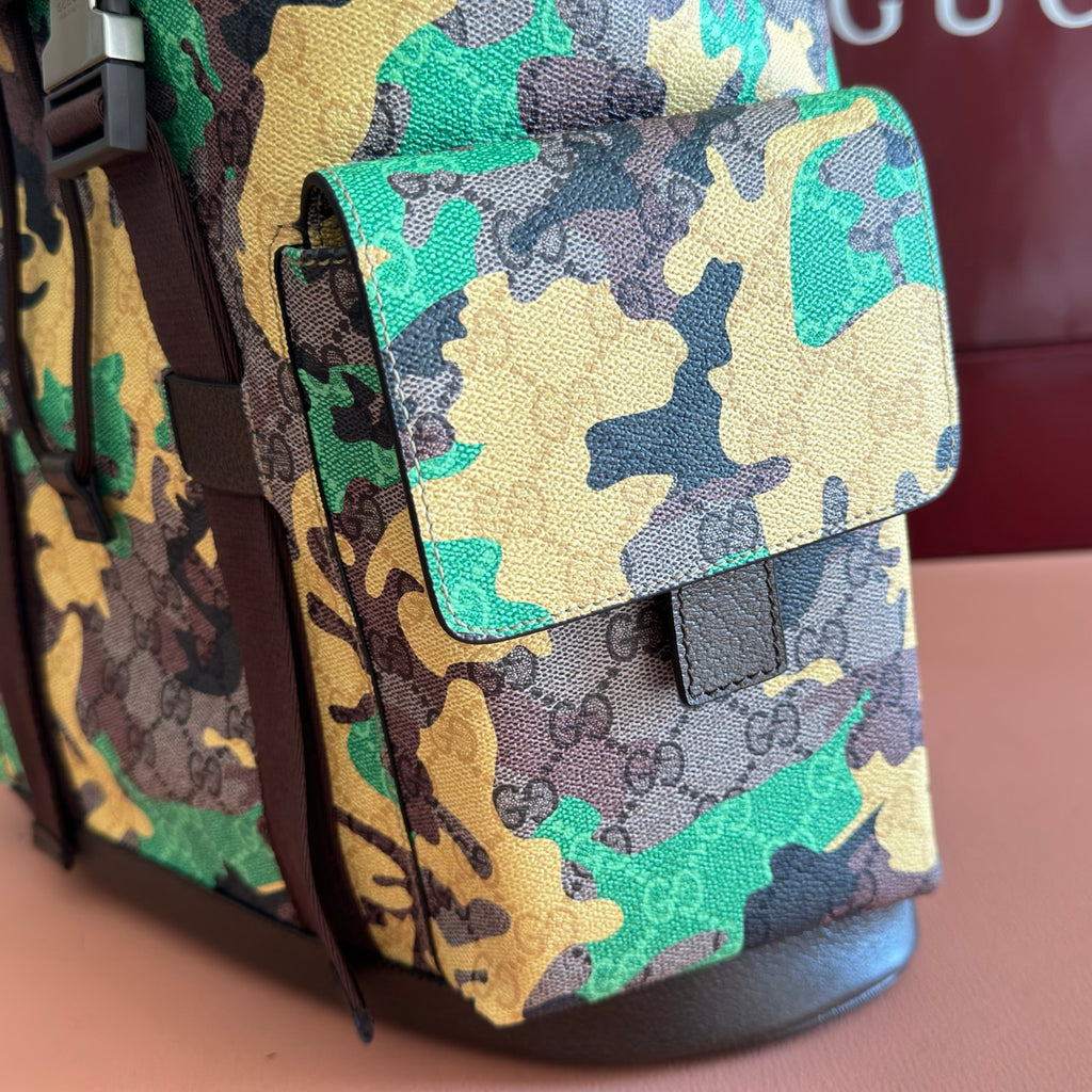 Camouflage backpack side pocket with flap tab and brown trim