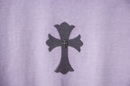 Lavender T-shirt front with dark cross patch and small gold accents