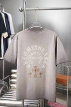 Light gray T-shirt with large back cross and ornamental lettering graphic.
