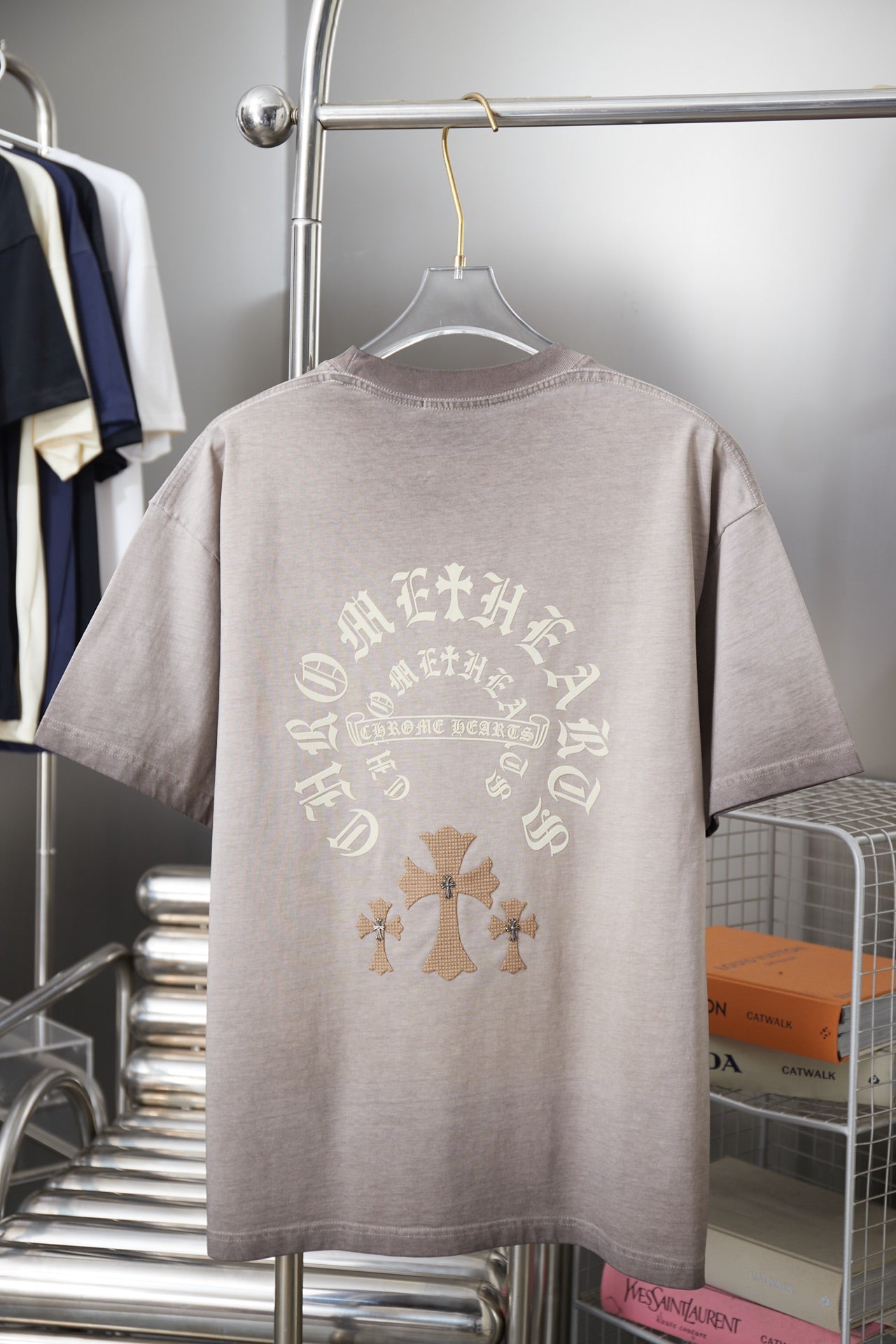 Light gray T-shirt with large back cross and ornamental lettering graphic.
