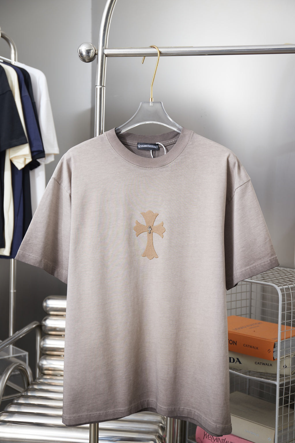 Light gray T-shirt with embroidered cross graphic at center front.