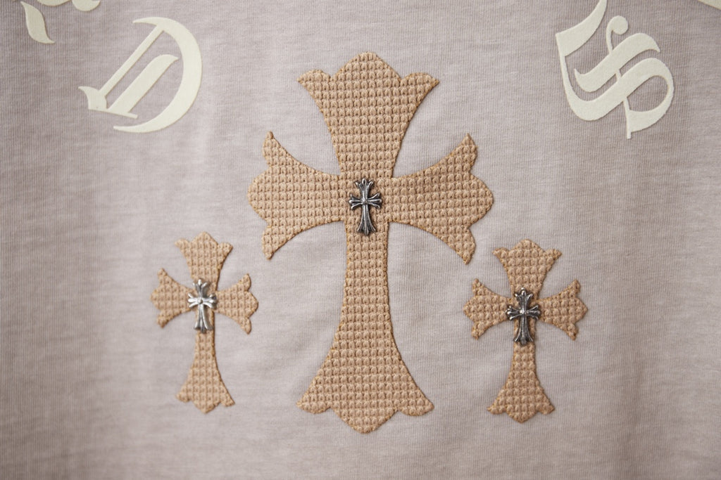 Light gray T-shirt embroidery with large cross and two smaller cross motifs.