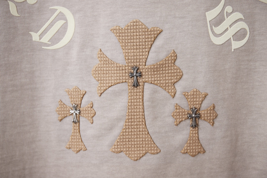 Light gray T-shirt embroidery with large cross and two smaller cross motifs.