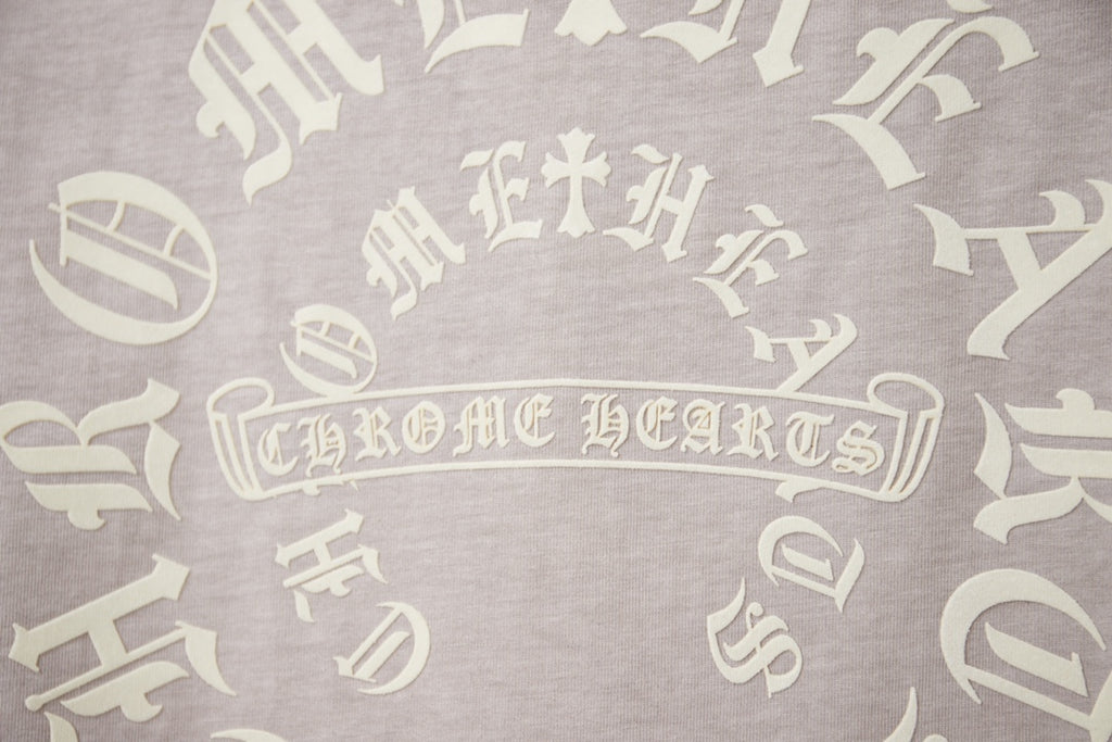 Light gray T-shirt back print with decorative gothic lettering motif.