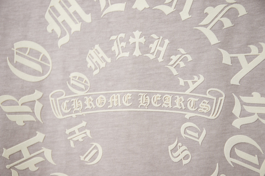 Light gray T-shirt back print with decorative gothic lettering motif.