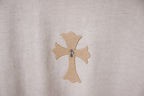 Light gray T-shirt with embroidered beige cross emblem detail.